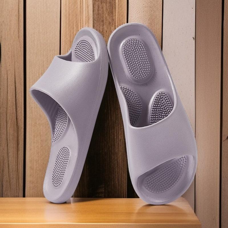 Pair of men’s and women’s bathroom slippers with massage feature