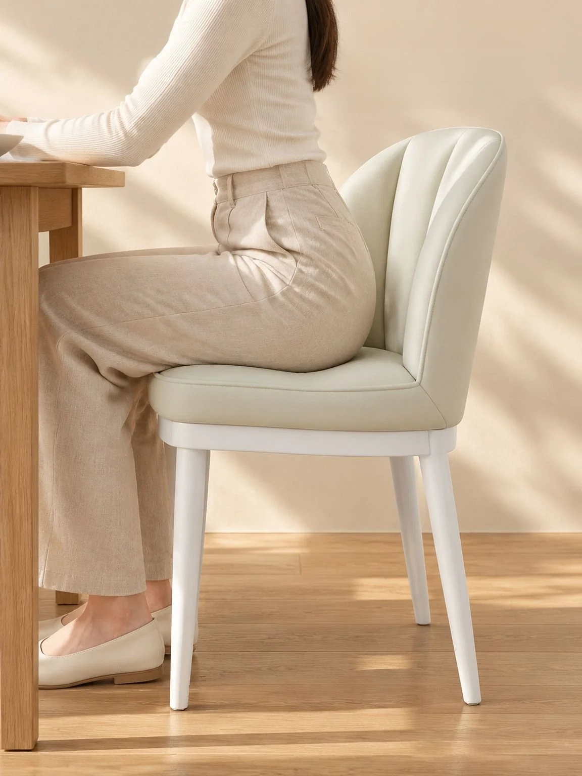 Cream dining chair styled in a bright modern dining room