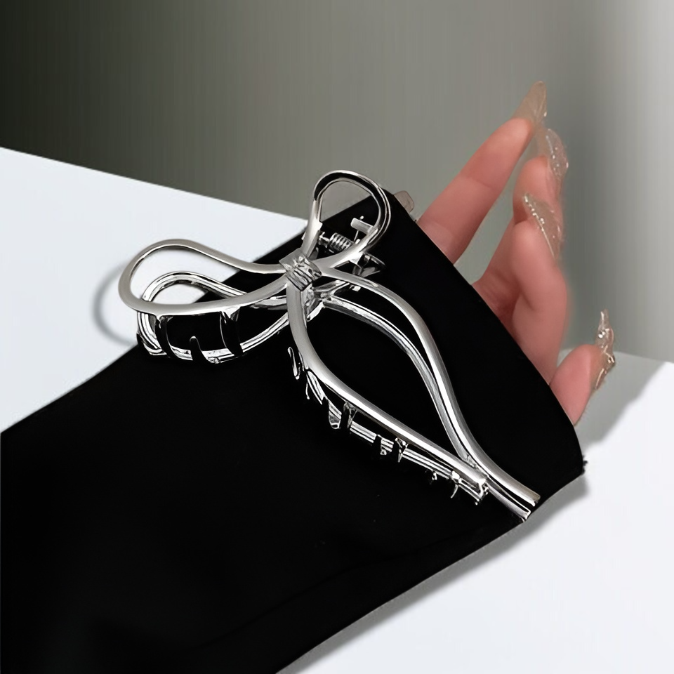 Bow metal hair clip clamping hair at the back of the head