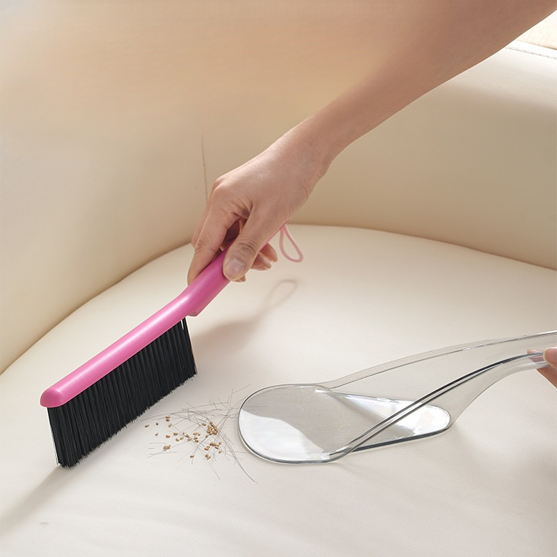 Colorful vacuum cleaner brush removing dust from fabric