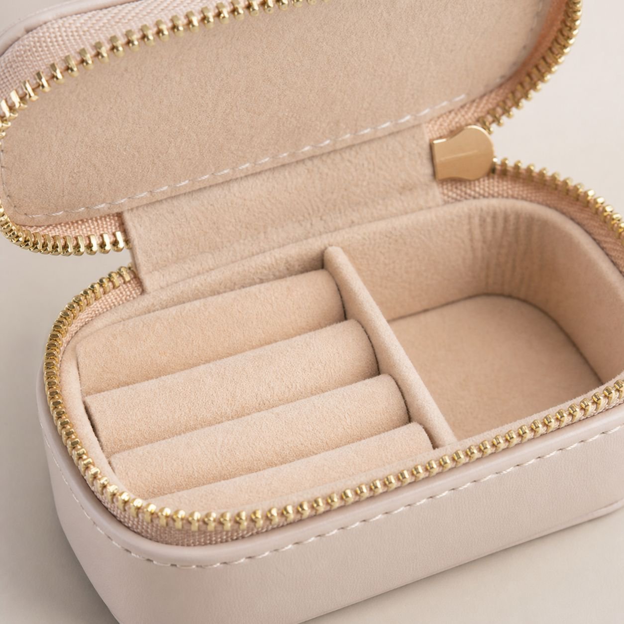 Open mini jewelry box showing compartments