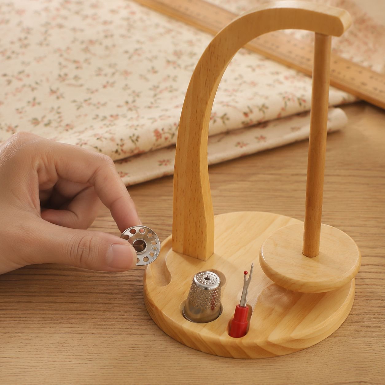 Sewing thread holder showcasing tool storage grooves