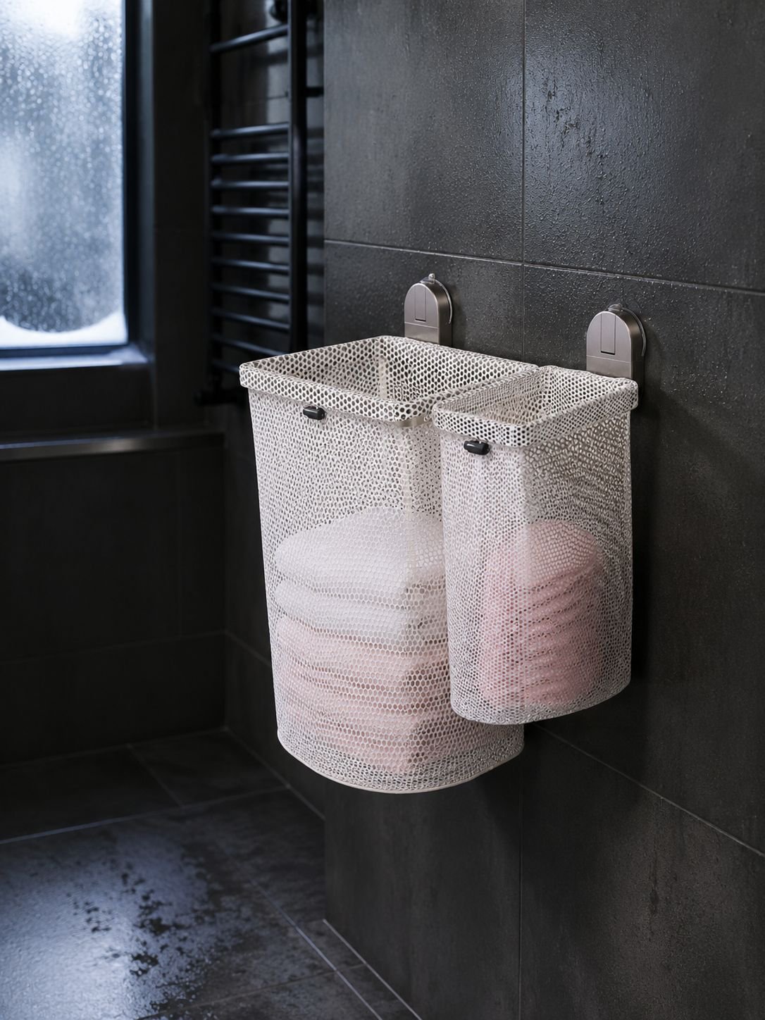 User placing clothes into wall-mounted foldable laundry hamper