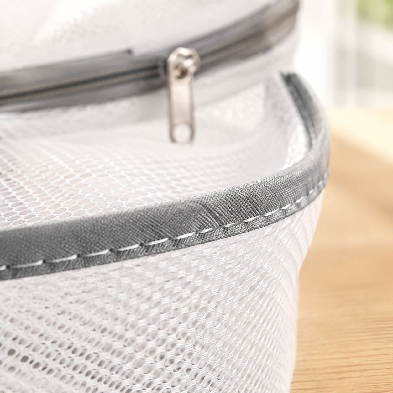 Secure zippered laundry drying basket holding clothes