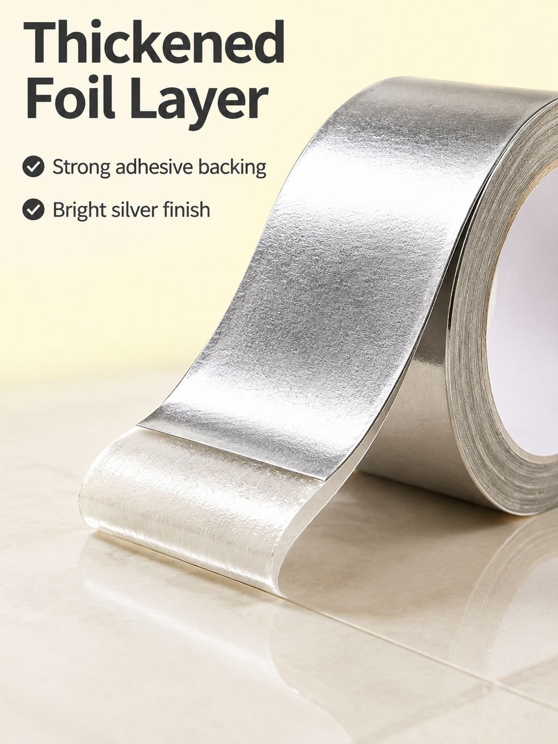 Self-adhesive aluminum foil repair tape unrolled on a table