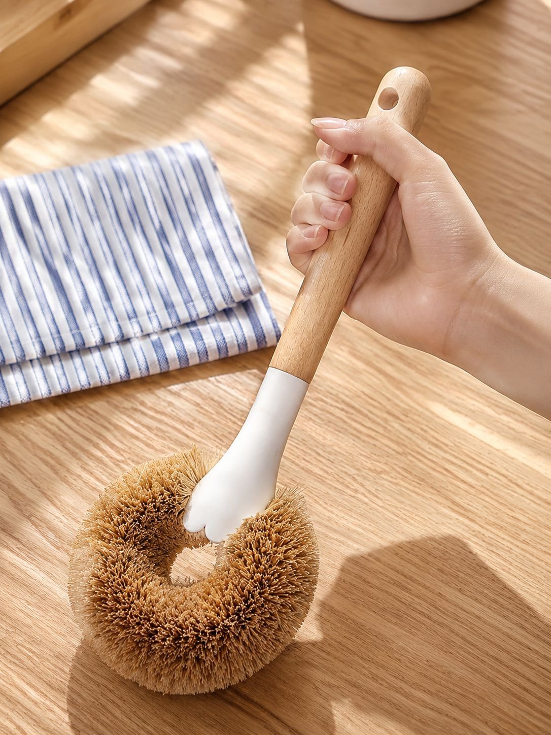 Natural fiber brush scrubbing pots and pans